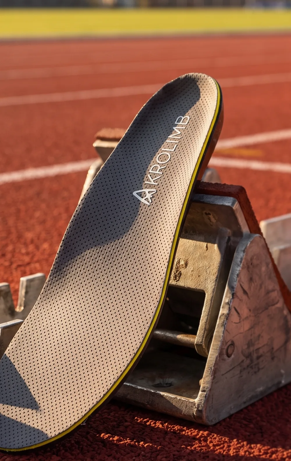 An Akrolimb Sport insole on a starting block on a running track